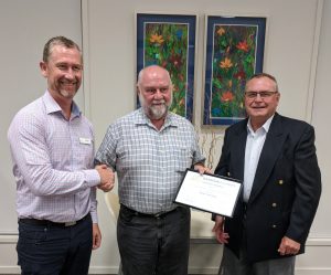 Current CEO Graham Wise (L) and Chair Stephen Palywoda (R) congratulate Phil at the AGM