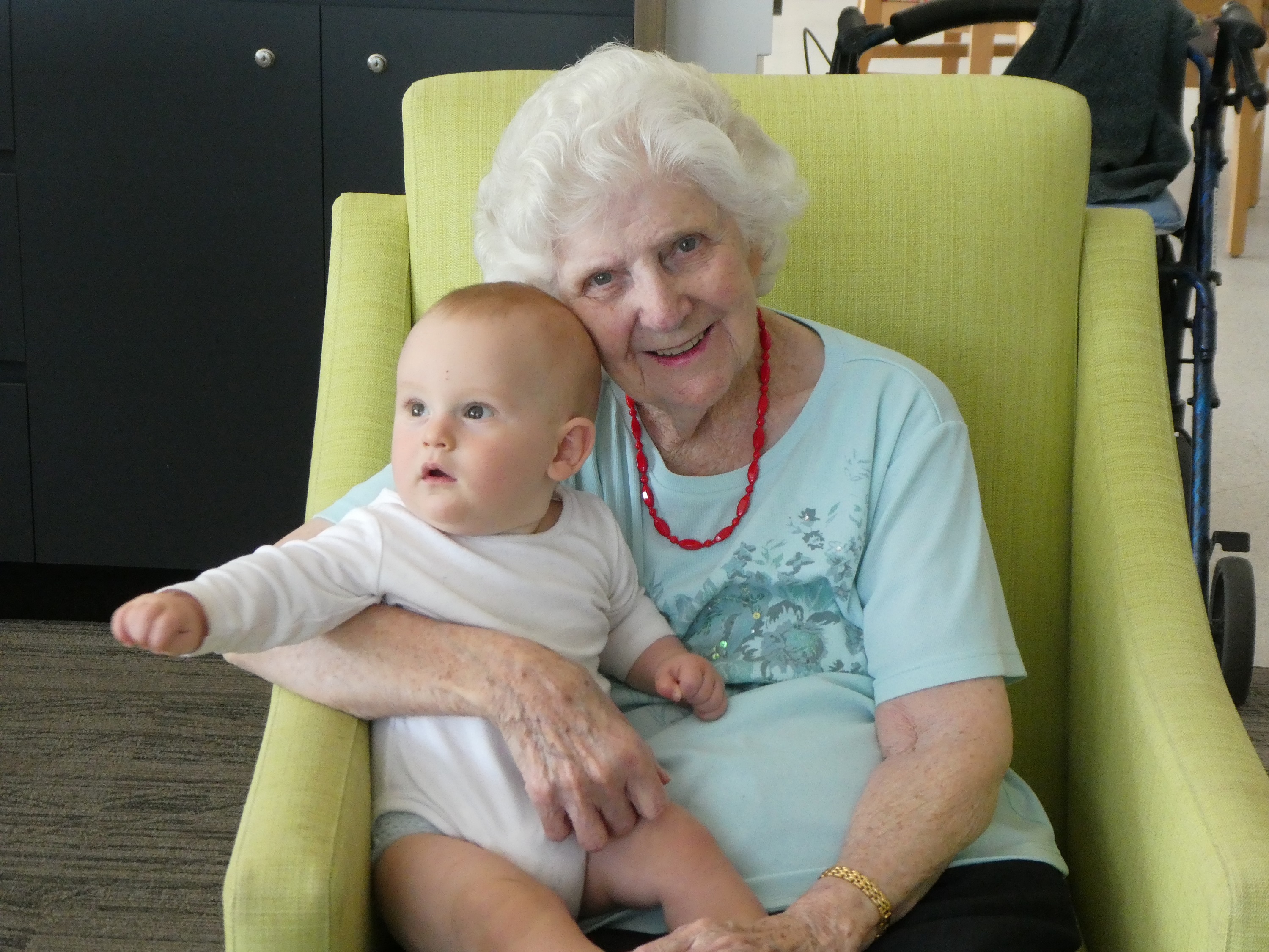 A Banksia Lodge Resident with a baby during an intergenerational playgroup
